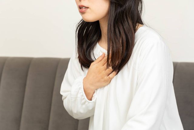 食道に違和感を感じている女性